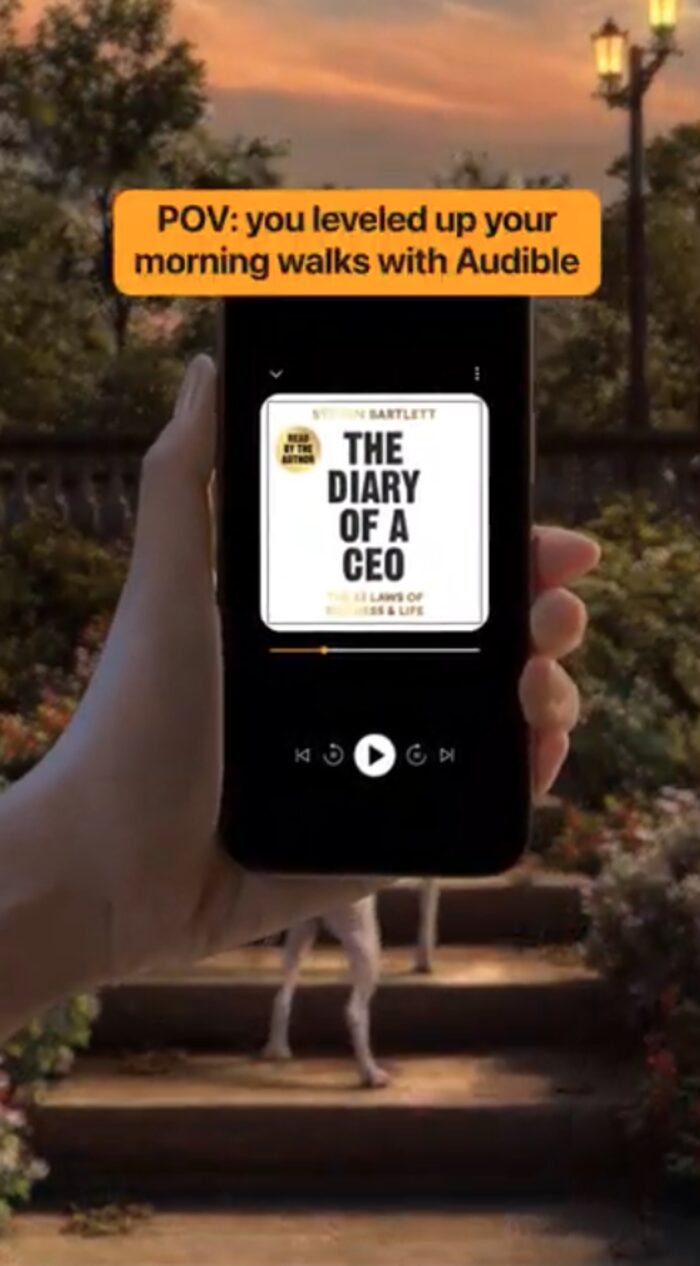 Audible ad creative: a phone showing an audiobook playing, styled as a POV morning walk moment